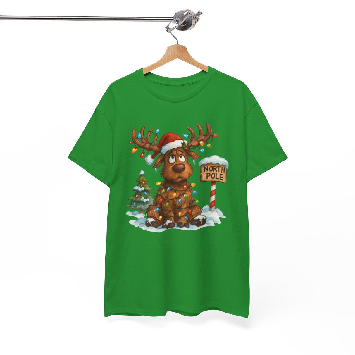 Flat lay of the Christmas Reindeer Tee alongside holiday decorations, showcasing its playful design for festive outfits.