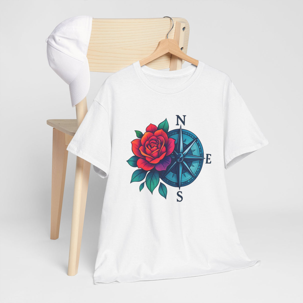 Compass Rose Tee — Red Rose Nautical Compass Graphic T-Shirt displayed with travel accessories, embodying adventure.