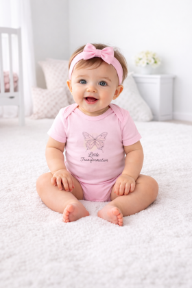 Stylish Baby Bodysuit featuring a playful kitten design, worn by a cute baby holding toy bottles, perfect for capturing precious moments.