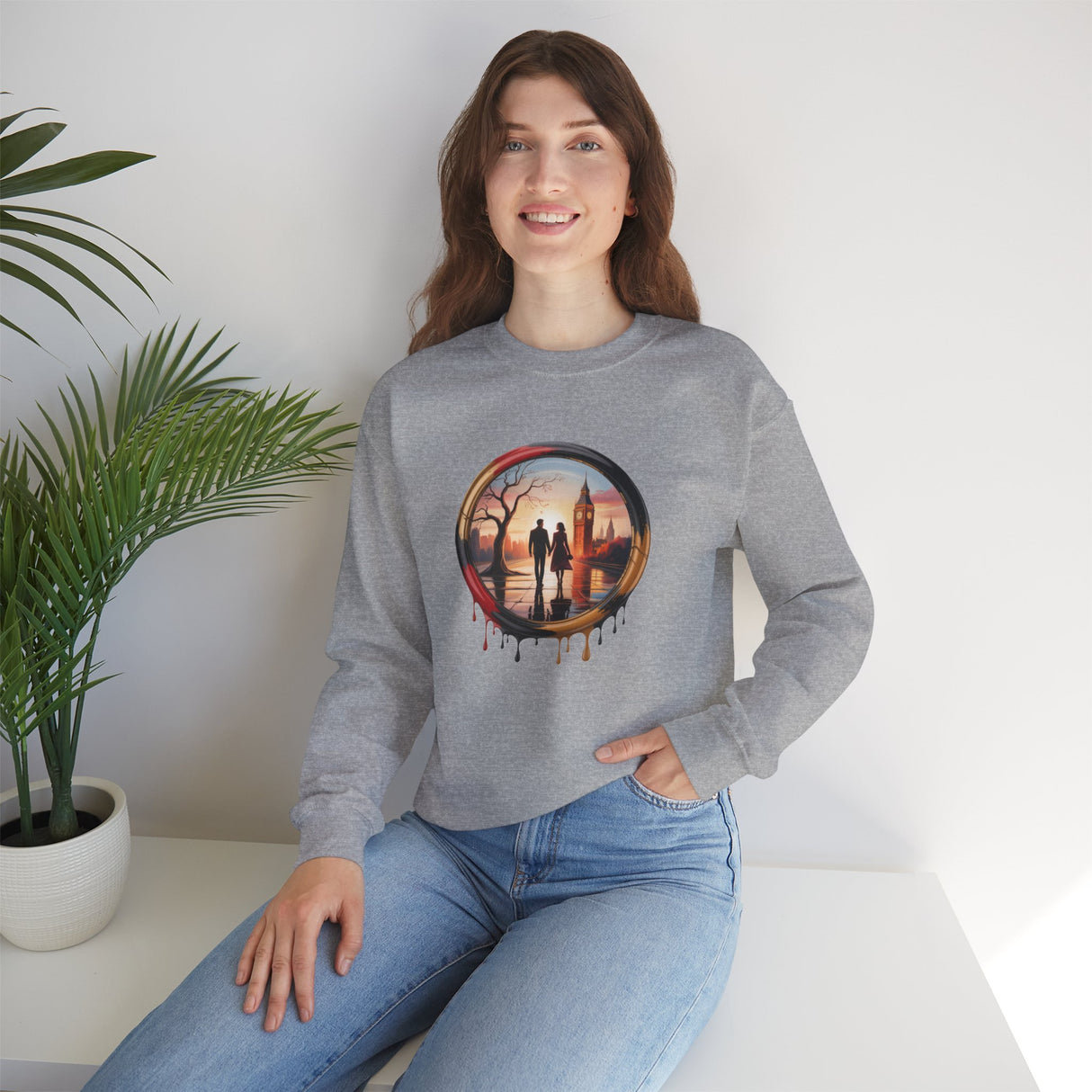 Model in Crewneck Sweatshirt featuring Sunset Couple Silhouette in Dripping Circle at a cafe, illustrating stylish comfort.