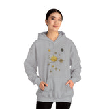 Model wearing the Celestial Compass Hoodie with gold star and sun astronomy graphic, styled with casual jeans.