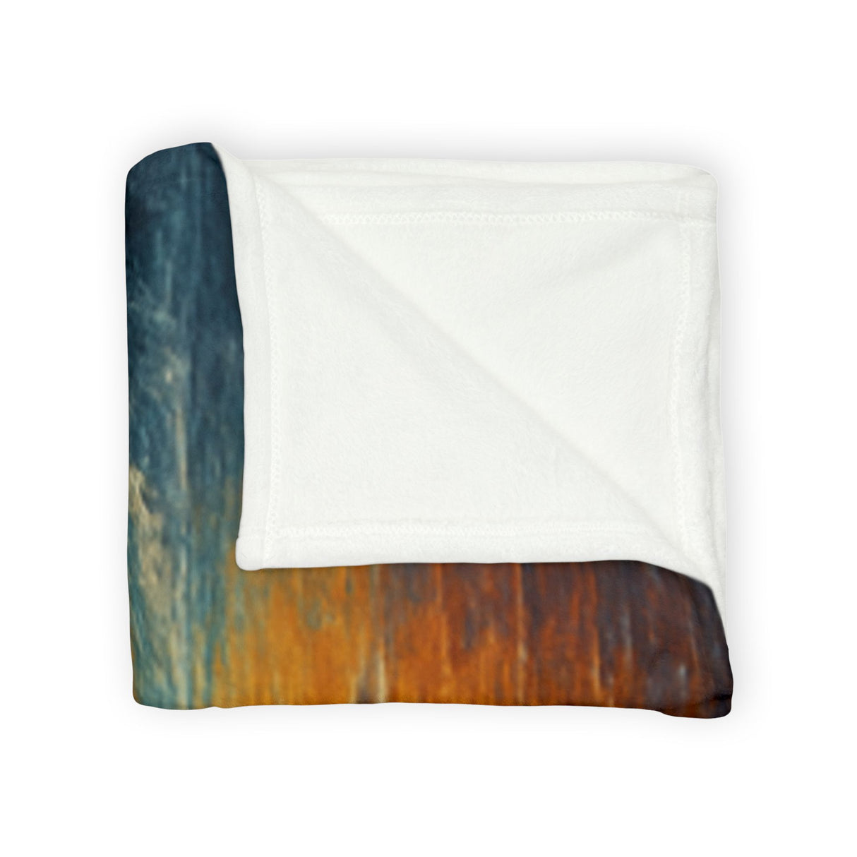 Cozy and plush Sailing into the Sun Fleece Blanket draped over a couch, highlighting its vibrant nautical sunset design.