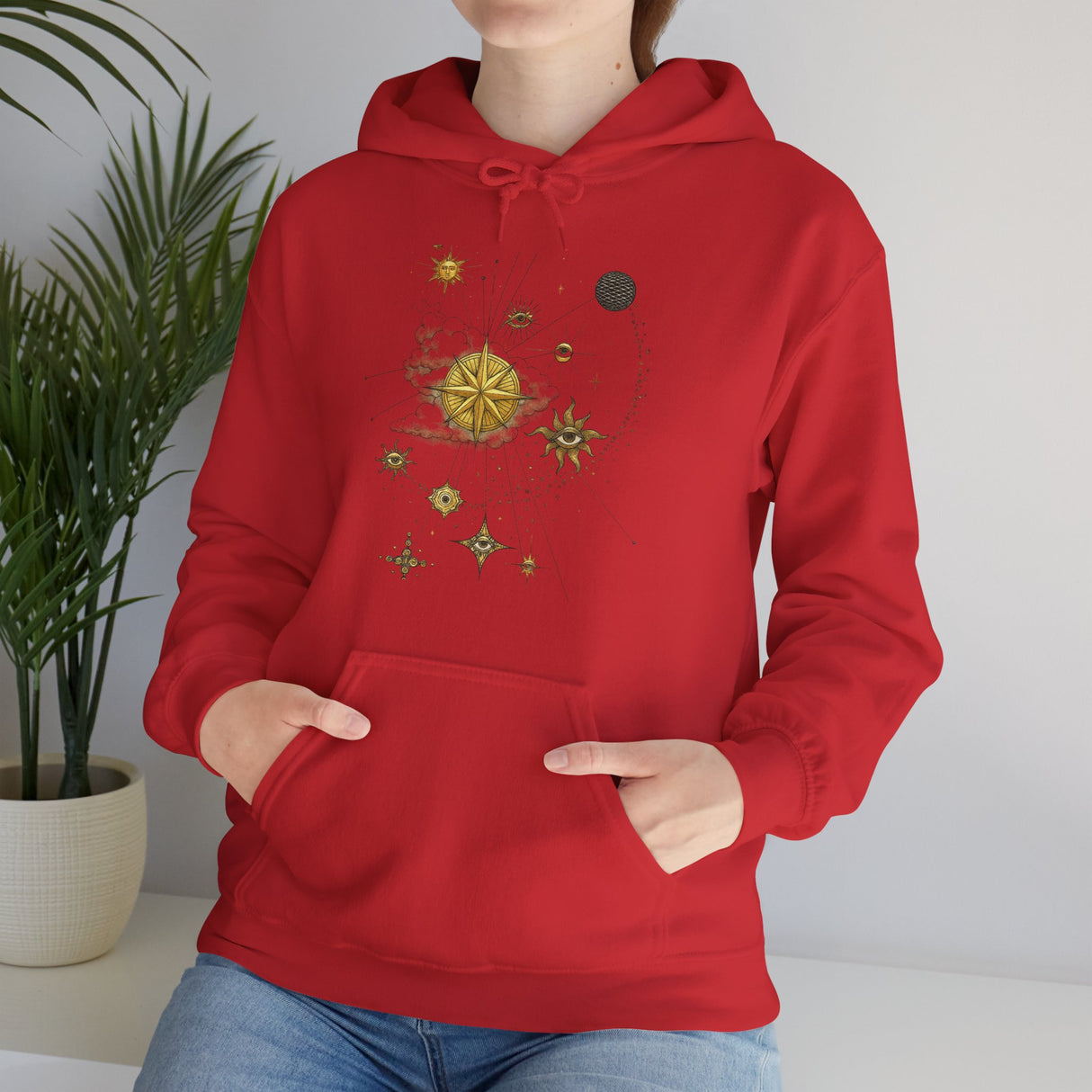 Lifestyle shot of the Celestial Compass Hoodie featuring gold star and sun graphics, perfect for stargazers.
