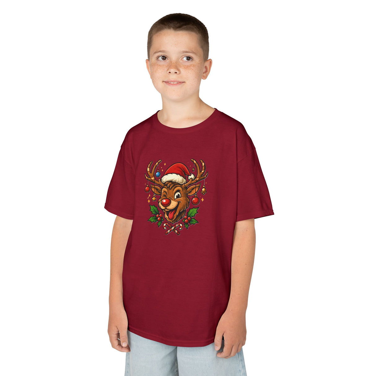 Kids Christmas Reindeer Tee — Cute Santa Hat Rudolph Holiday Shirt displayed with matching holiday-themed props.