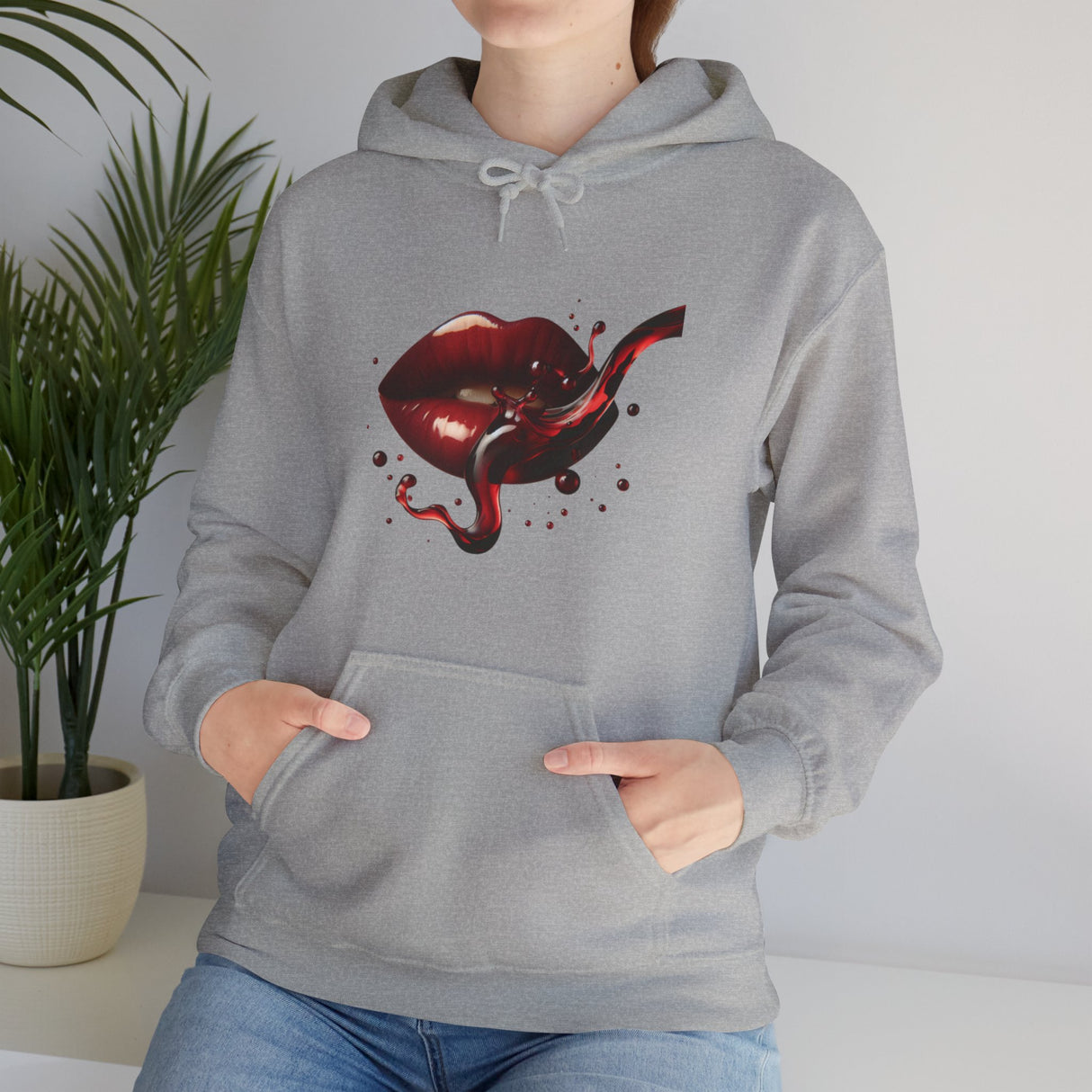Flat lay of the Lip Bite Hoodie styled with accessories, highlighting its trendy appeal.