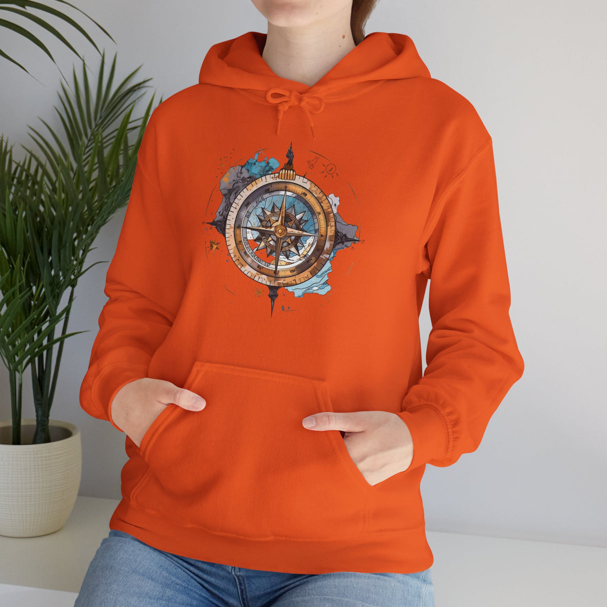 The Compass Rose Hoodie paired with rugged outdoor gear for an adventurous look.