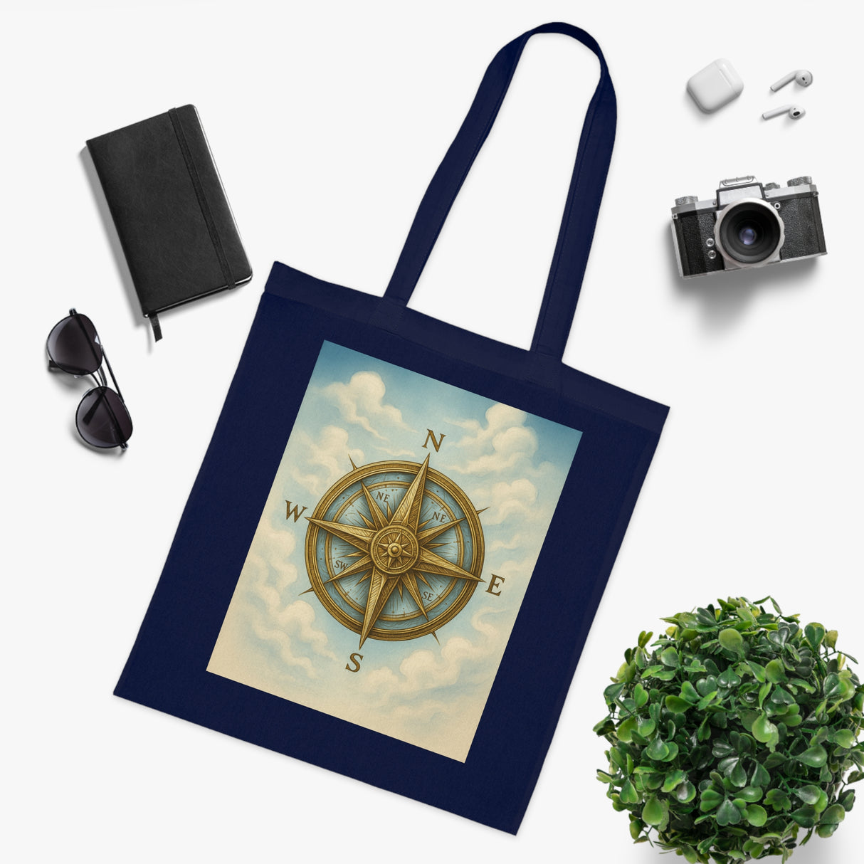 Person carrying the Vintage Compass Cotton Tote Bag during a beach outing enjoying the sun.