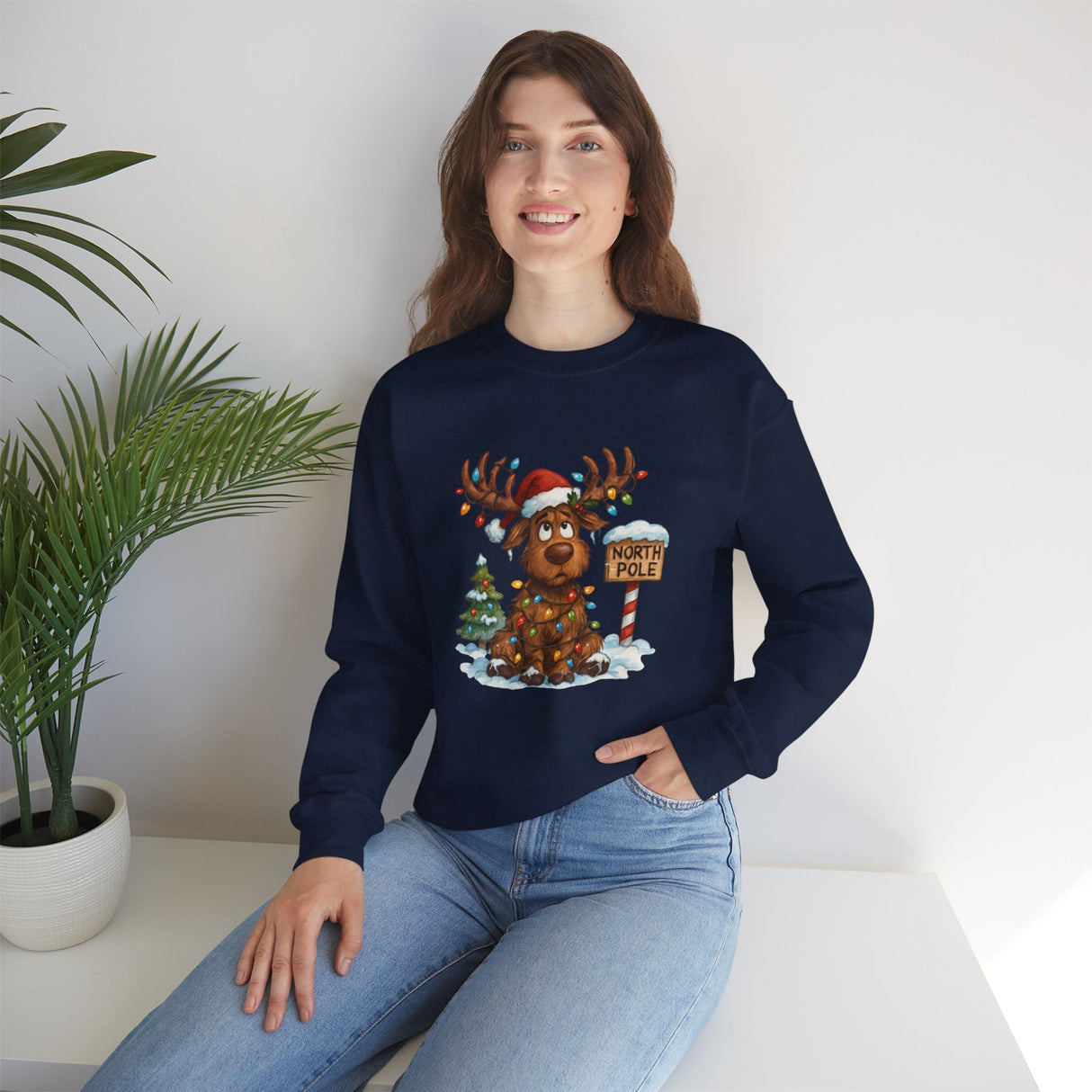 Cute North Pole Holiday Sweater Women Sweatshirt with images of a reindeer in festive lights and a snowy background.
