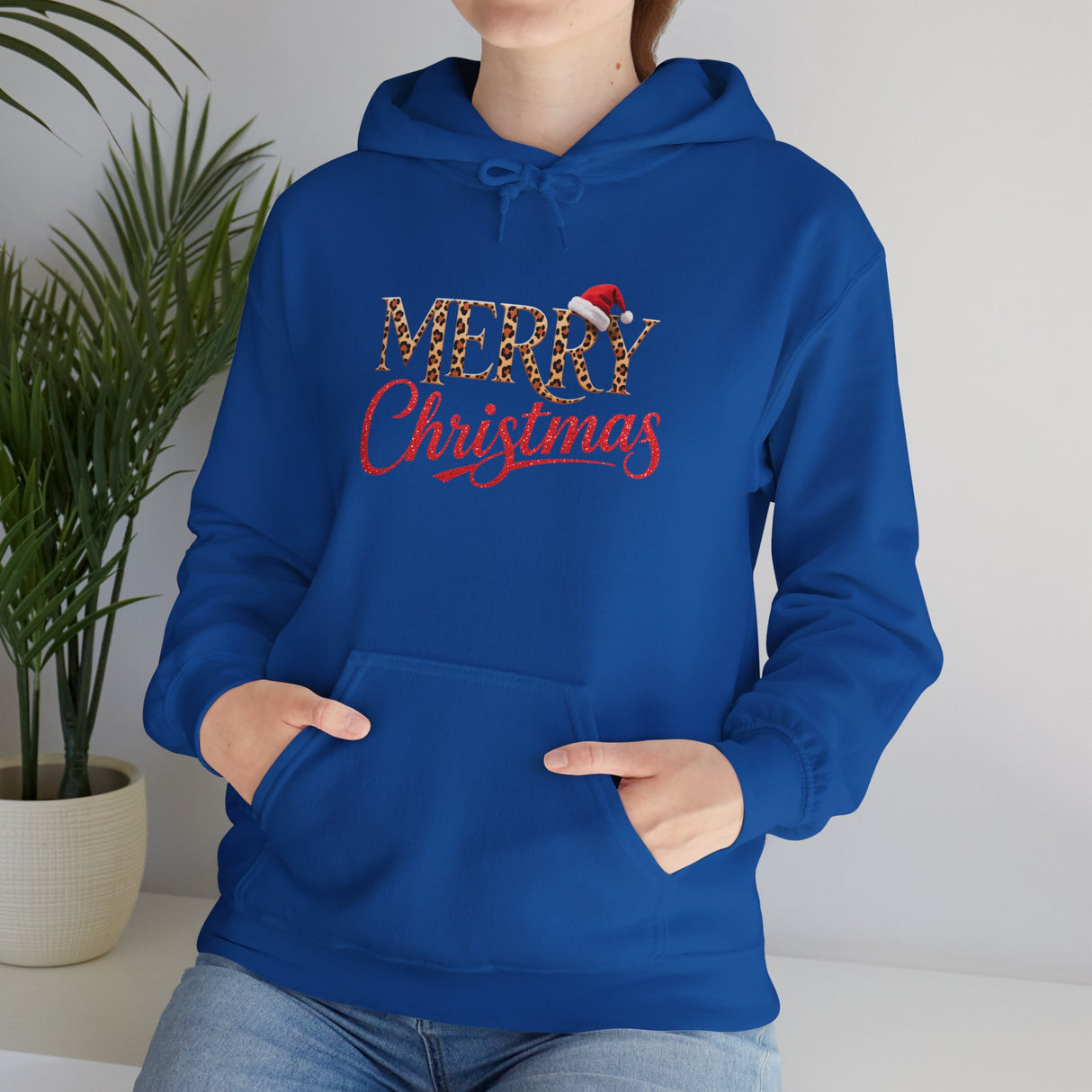 Merry Christmas Hoodie displayed with a cup of cocoa for cozy winter aesthetics.