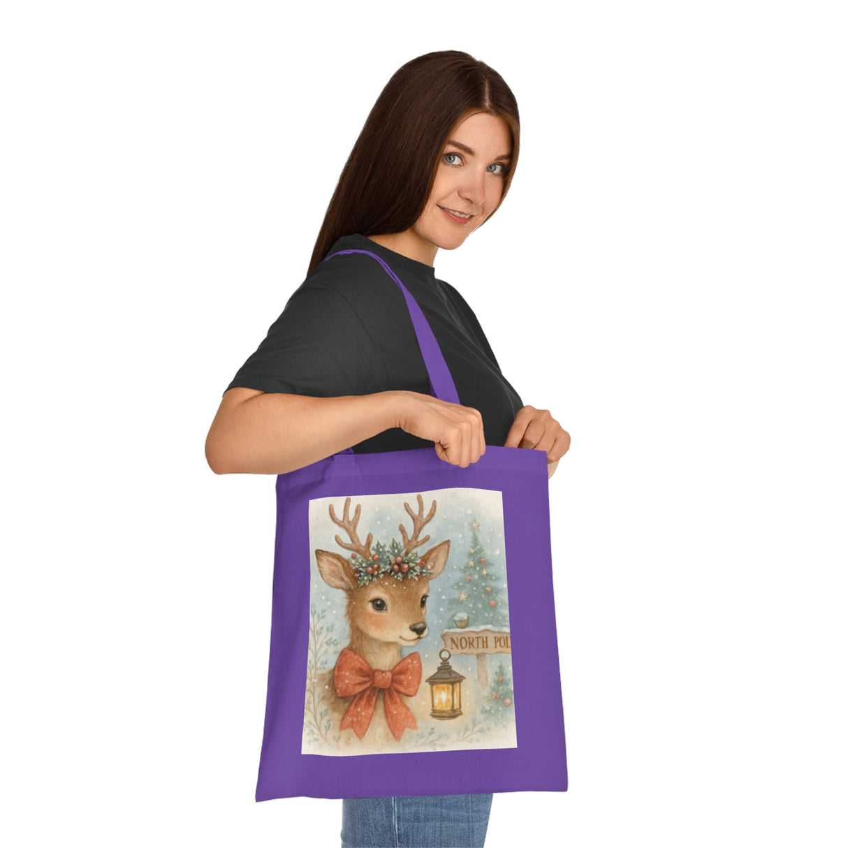 The Christmas Reindeer Tote Bag hanging on a chair with holiday decor in the background.