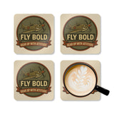 Vintage Airplane Cork Coaster Set - 'Fly Bold' Design displayed with drinks on a coffee table.