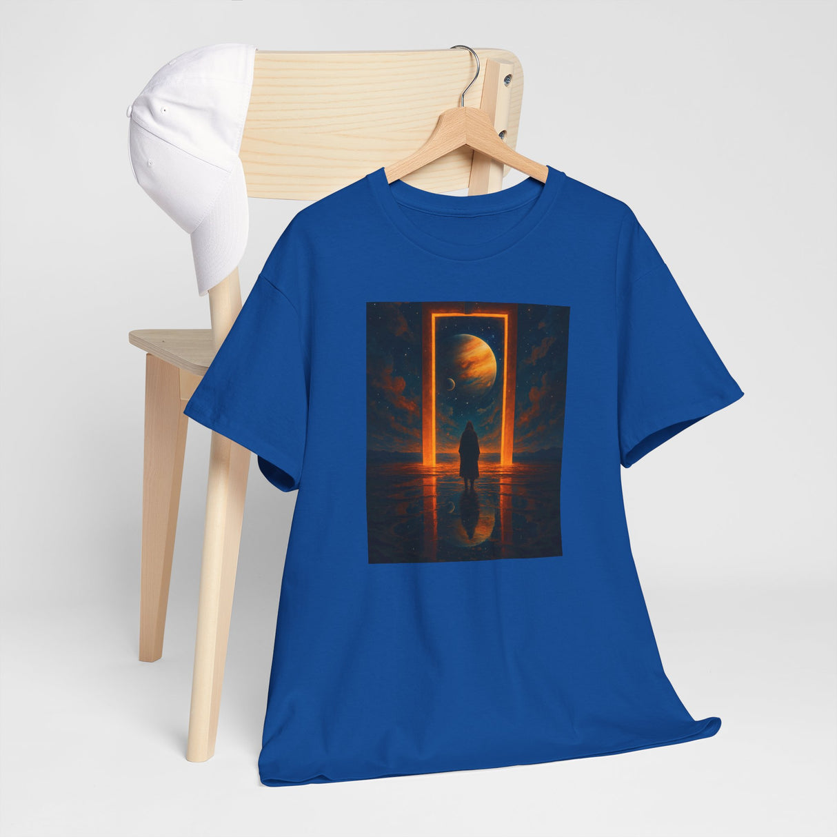 Surreal Portal Moon Tee laid out on a textured surface, emphasizing its vibrant design.