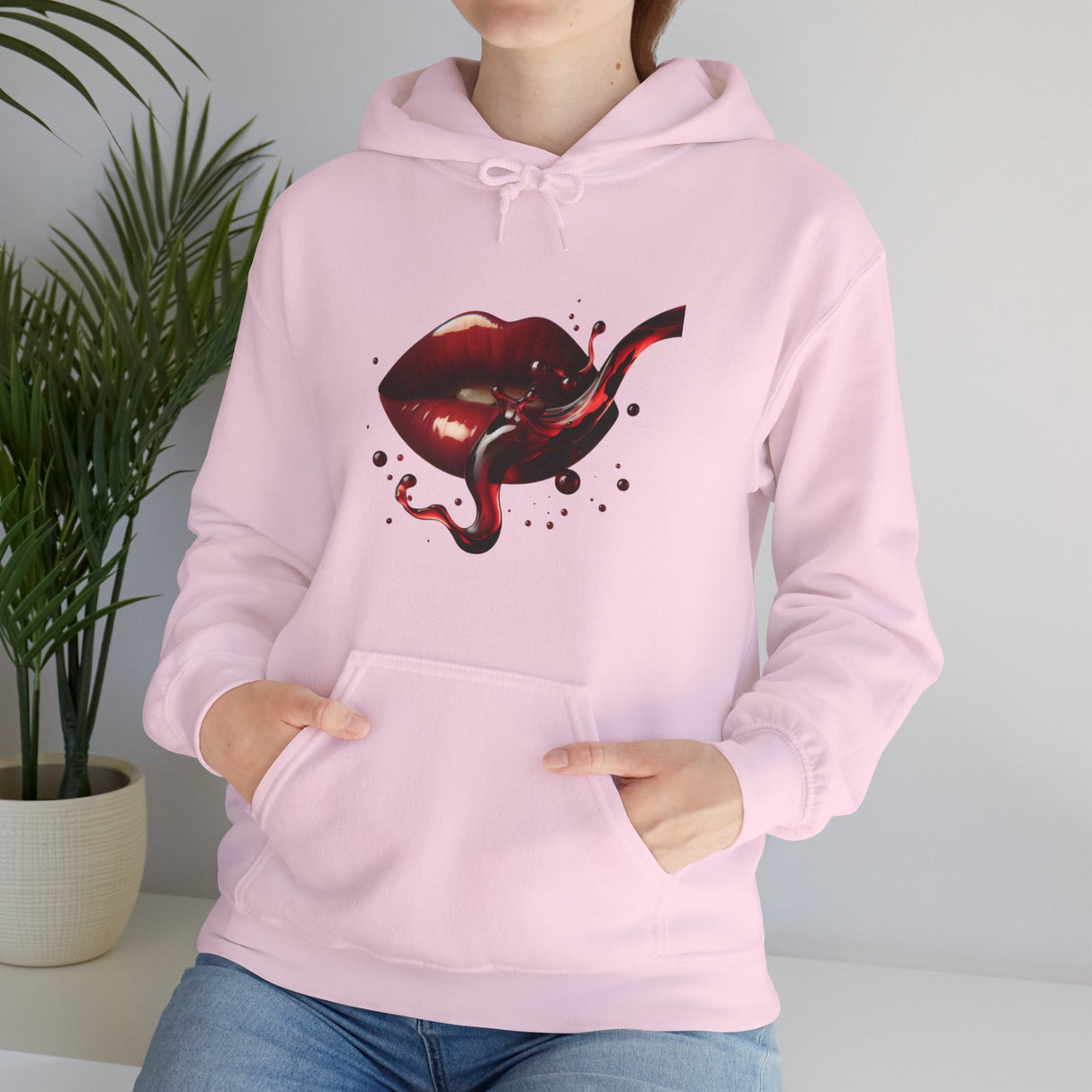 The Lip Bite Hoodie, capturing the moody reds of its graphic design for a stylish statement.